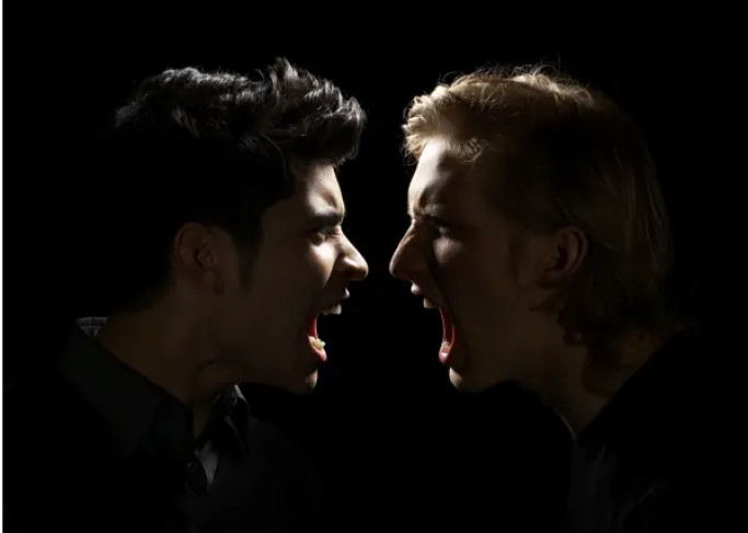 Two people face each other in profile, mouths open as if shouting, against a black background.